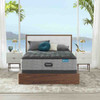 mattress styled with white and gold nightstands in front of a tropical background