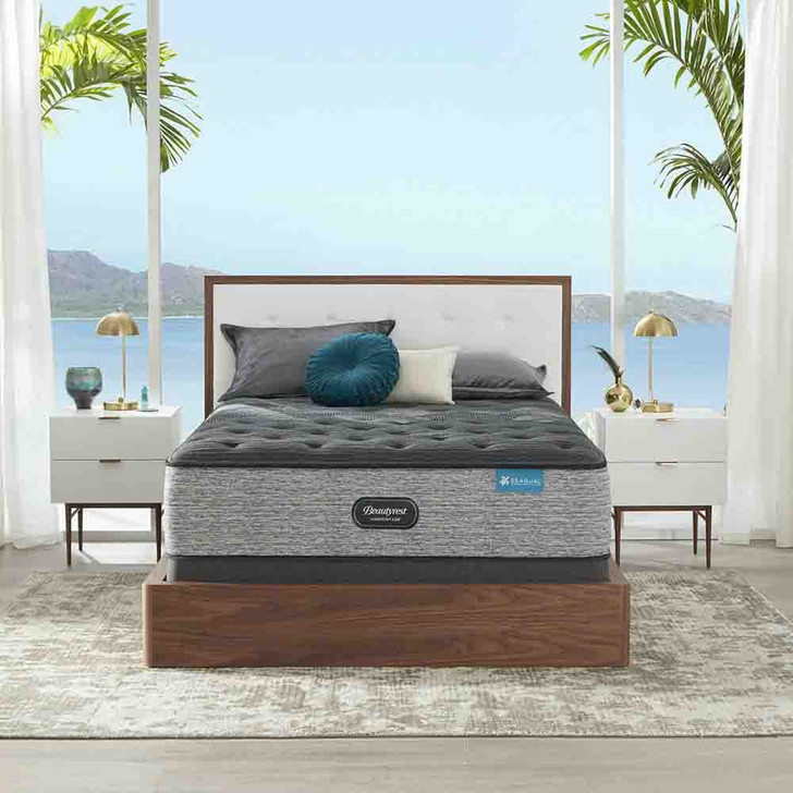 mattress styled with white and gold nightstands in front of a tropical background