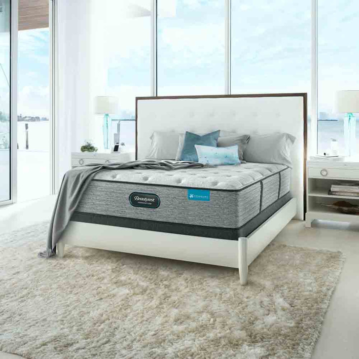 mattress styled with white and gold nightstands in front of a tropical background, three quarters left facing view.